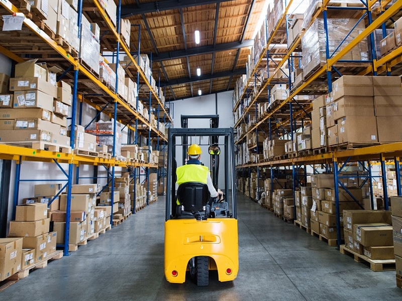 warehouse PCC Logistics Employee Navigating Warehouse